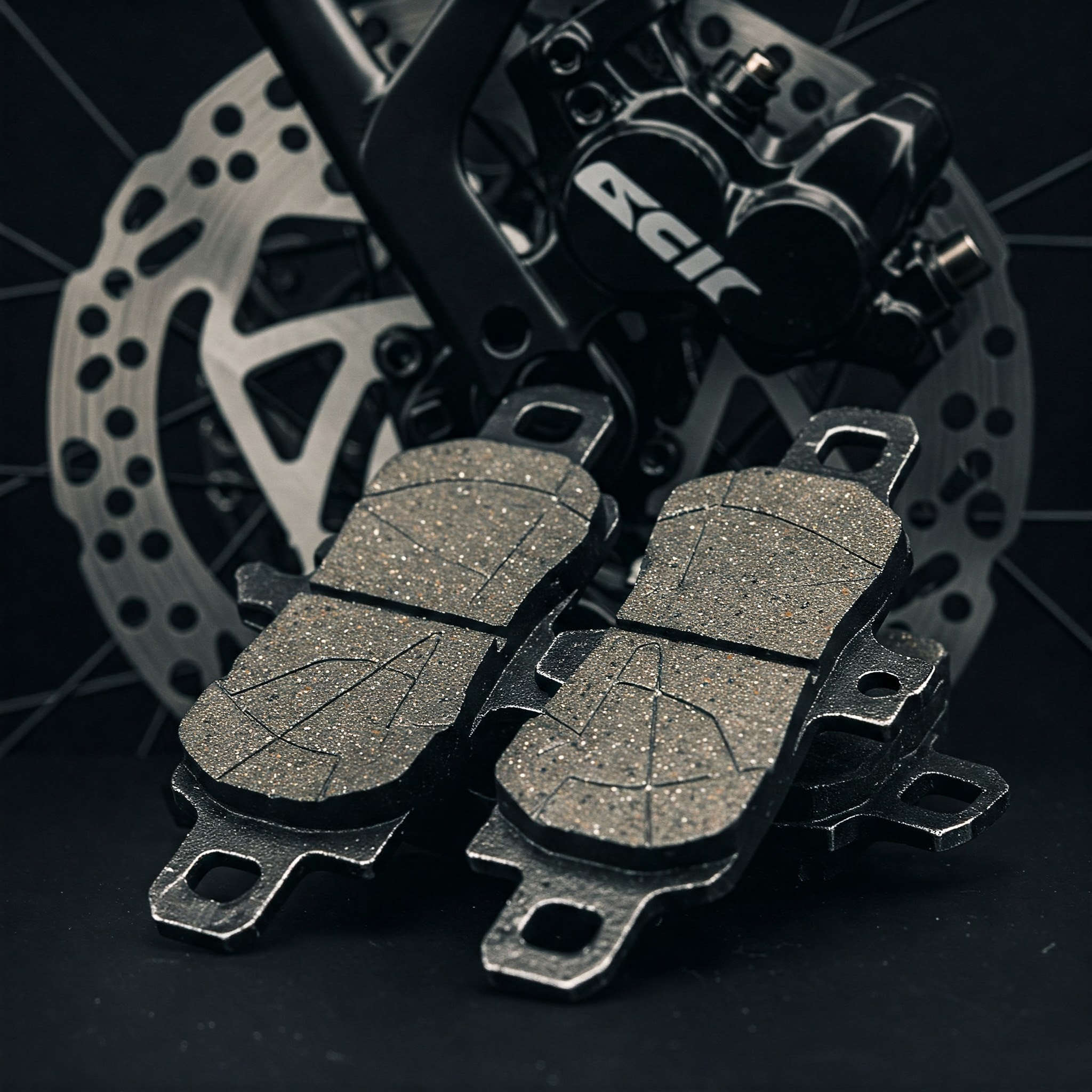 "Close-up of new e bike brake pads ready for replacement on a bicycle disc brake system."