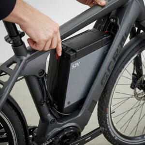 Installing a 52v ebike battery into the frame of an electric bicycle.