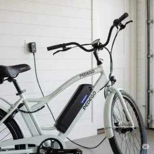 A Pedego electric bike connected to a charger at home, demonstrating the ease of charging discussed in many pedego electric bikes reviews.
