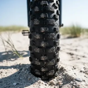 Close-up detail of the fat tire tread, essential for stability and grip on sand or snow, common on electric fat tire bikes under 1500.