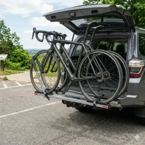 Showing the convenient tilt-away feature of a hitch bike rack with ramp for road bikes for trunk access.
