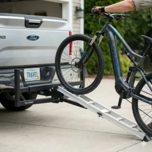 Using the ramp to roll an e-bike onto the carrier after completing the hitch bike rack with ramp installation.
