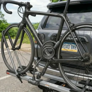 Integrated cable locks ensuring high security on a hitch bike rack with ramp for road bikes.